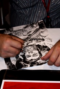 Tony Moore sketches something other than zombies at his table. Photo By: Alexa Tomaszewski