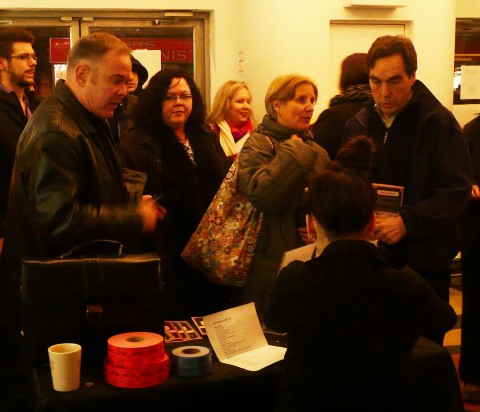 Stephen Lipson and Richard Comely buying their tickets. Pay attention to that brief case... No, it's not a bomb... at least not in the sense you might think.