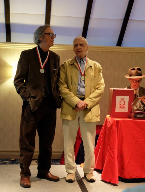 Gerald Lazare and Jack Tremblay on stage receiving their awards.