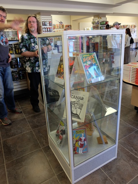 short display case from opposite angle with James Waley in background.