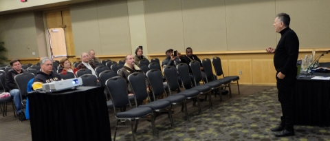 Michael Hirsh addressing our panel audience (notice Jim Finlay, Eddy Smet and his wife Zorka in the middle, Brian, and the guys from Comix Asylum)